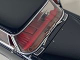 a black car with a red seat in the back of it