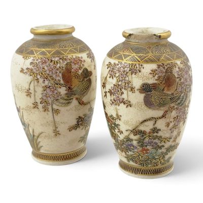 pair of asian vases decorated with birds and flowers on a white background