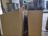 two cabinets that are sitting on pallets in a garage