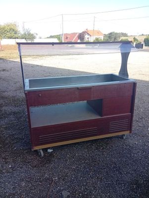 a small display case sitting on top of a gravel ground