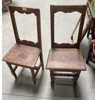 pair of antique wooden chairs with a mirror on the back of them
