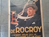 a poster on the wall of a building with a picture of a man in a hat