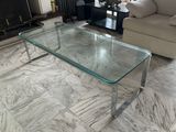 a glass coffee table in the middle of a living room