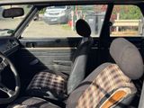 a car with a plaid seat cover in the back of it