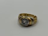 a close up of a gold ring with a diamond in the center