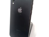 a black iphone sitting on top of a stand