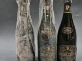 three bottles of wine wrapped in plastic and wrapped in plastic wrap