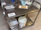 a stainless steel table with dishes on it in a kitchen