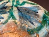 a close up of a vase with a flower design on it