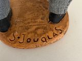 a figurine of a person standing on a coin