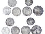 an image of a group of silver coins on a white surface