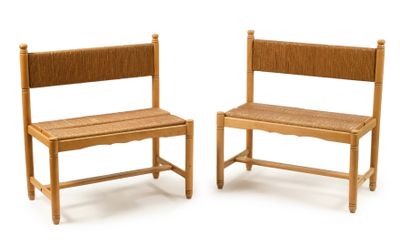 two wooden chairs sitting next to each other on a white surface