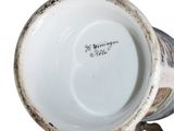a close up of a coffee cup on a stand