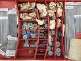 a red box filled with assorted buttons and other items