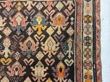 an old rug with a design on it on a white surface