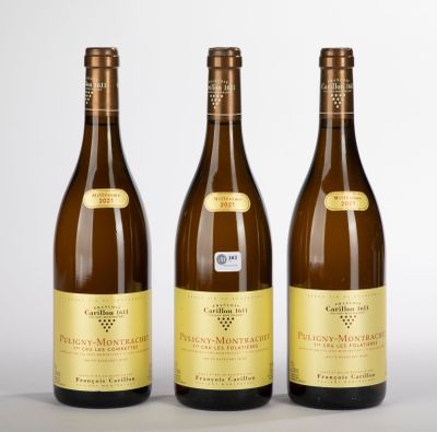 trois bouteilles de vin posées l'une à côté de l'autre sur une table