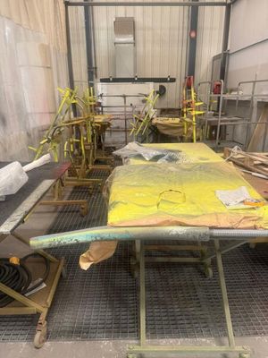 a yellow surfboard sitting on top of a table in a room