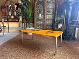 a yellow table that is sitting in a room