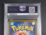 the pokemon card is in a clear plastic holder on a table
