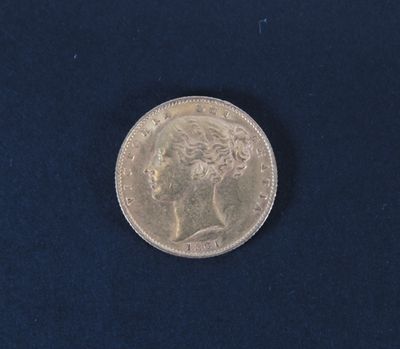 a close up of a silver coin on a blue surface