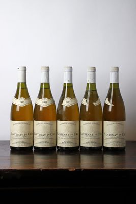 six bottles of wine are lined up on a table