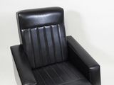 a black chair that is sitting on a white floor