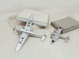 two toy airplanes sitting next to each other in a box