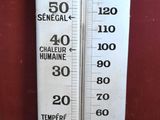 a blue and white thermometer on a wooden table
