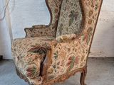 a chair that has a floral upholstered seat on it