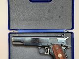 a gun in a blue case on a white surface