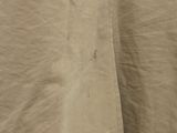 a close up of a tan shirt with buttons on it