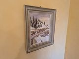 a picture of a painting hanging on the wall above a bed