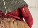 a small doll that is sitting on a chair