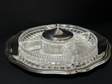 a glass tray with a silver lid on a black table
