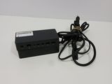 a black power supply that is plugged into the wall