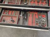 a tool drawer with tools in it in a garage