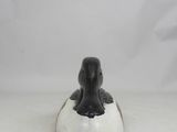 an elephant figurine sitting on top of a white surface