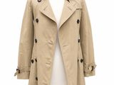 a woman ' s trench coat on a mannequin mannequin mannequin mannequin mannequin mannequin mannequin mannequin