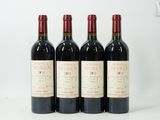 trois bouteilles de vin rouge sont alignées sur une surface blanche