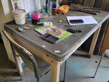 a table that has a laptop on it and a cell phone on it