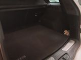 the back of a car with its trunk open in a garage