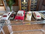 a lot of toy cars sitting on a glass table