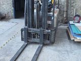 a forklift sitting in the middle of a warehouse