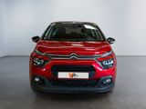 the front of a red citrole car in a showroom