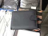 a black wallet sitting on top of a suitcase