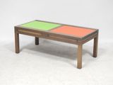 a wooden coffee table with two colored drawers on top