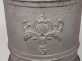 an old cast iron pot sitting on a stand