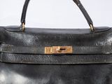 an image of a black leather handbag on a white surface