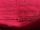 the back of a pink purse with a monogram on it