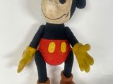 disney mickey mouse plush toy sitting on a white surface